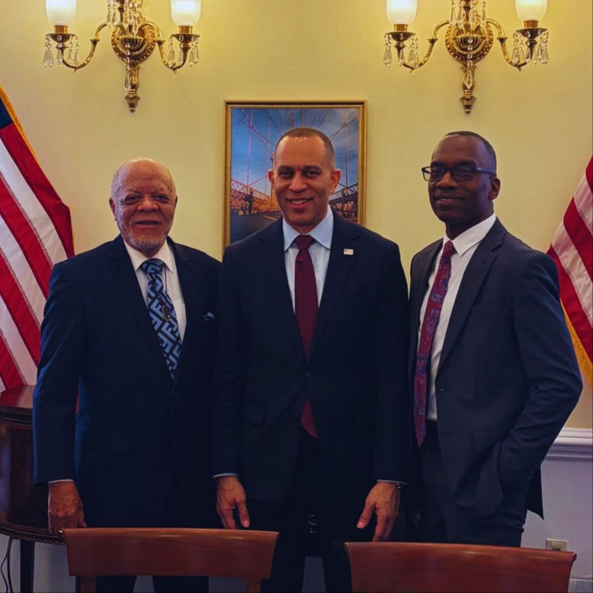 Dr. Michael Thompson posing with two men in the same group photo.